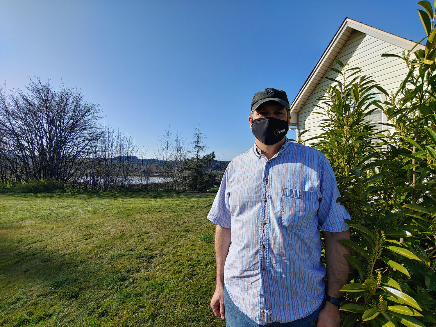 Scott Crossfield stands in his yard. The gravel pit can be seen behind him.